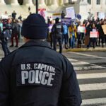 Uniformed MAJOR Arrested On Capitol Steps Police officer monitoring a protest on a city street