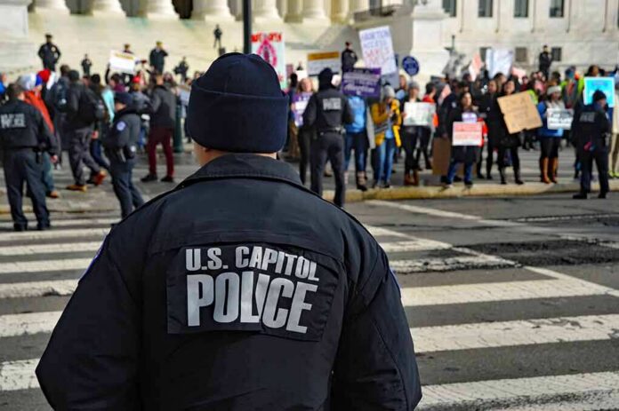 shutterstock_1297580413-1 Police officer monitoring a protest on a city street