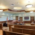 Kirk Family Attorney Makes a Stunning Move in Assassination Hearing Empty courtroom with wooden benches and judge's bench