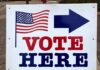 voting sign with arrow and American flag