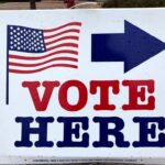 Shock Poll Shows GOP Getting Annihilated In Red Districts voting sign with arrow and American flag