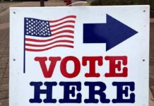 Shock Poll Shows GOP Getting Annihilated In Red Districts voting sign with arrow and American flag