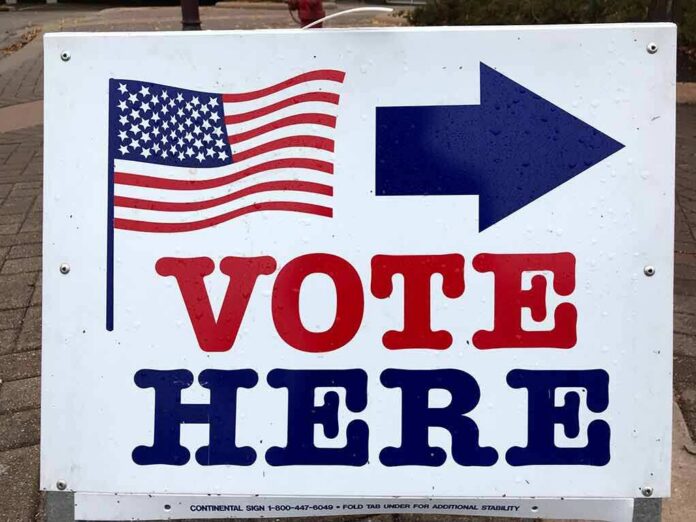 voting sign with arrow and American flag