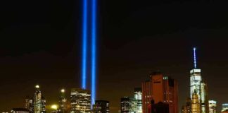 New York City skyline at night with twin blue light beams