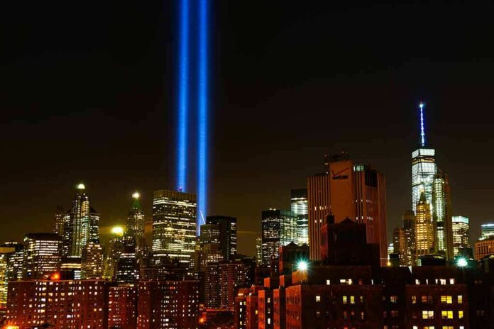 shutterstock_1495332722 New York City skyline at night with twin blue light beams