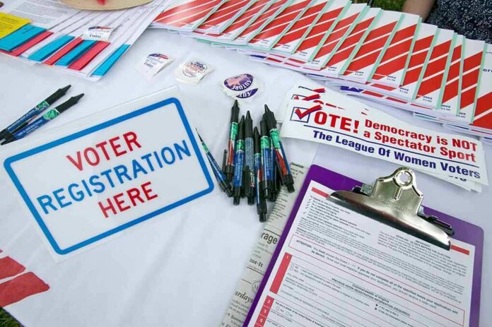 shutterstock_177445370-3 Voter registration table with forms, pens, and informational materials