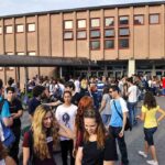 Military Recruiting SURGES — First Time in 15 Years Students gathered outside a school building entrance
