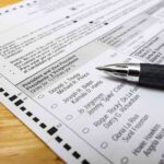 DHS Witch Hunt Falls Apart as It Can’t Name a Single Noncitizen Voter Ballot paper with pen on wooden surface
