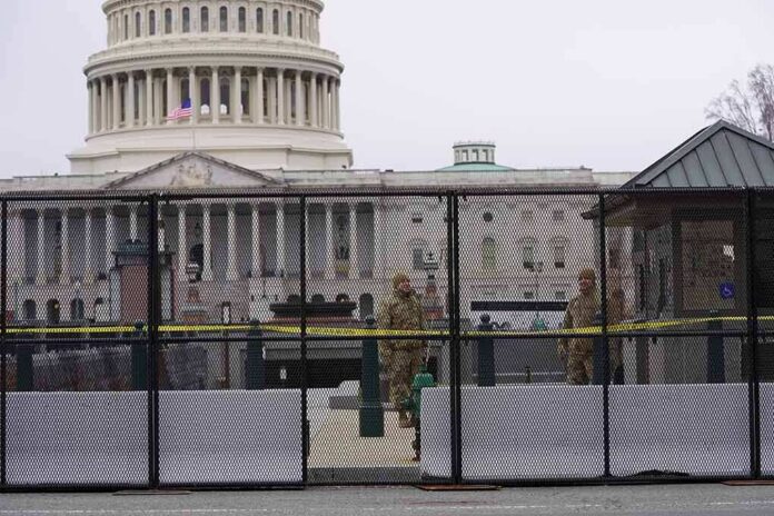 US Capitol behind security fence with guards