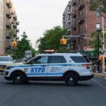 NYPD police SUV blocking a city street at a taped-off scene