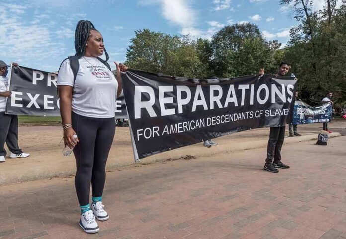 Protesters holding a large reparations banner outdoors