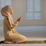 Tax-Funded Ramadan Sparks Lawsuit Woman in hijab praying on a mat indoors