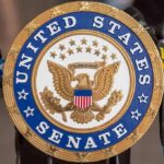 United States Senate seal at a podium