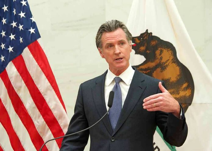 Gavin Newsom speaks at a podium with U.S. and California flags behind him