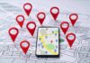 Travel App Outs U.S Troops Homes Smartphone with map app surrounded by red location pins