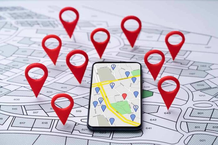 Smartphone with map app surrounded by red location pins