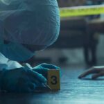 Judge Visible CLINCHES During Kirk Murder Trial forensic investigator in protective suit examining crime scene markers