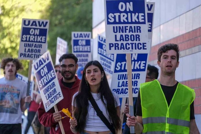 Group of protesters holding blue strike signs while marching