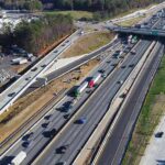ICE Chase Ends – Illegal WHACKED By Semi! Aerial view of multi-lane highway interchange with overpass and traffic