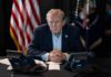 Trump Tells Rally-Goers To PAY High Gas Prices Person in suit seated at table with telephones