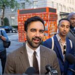 Mamdani Endorses Candidate Who Called America a ‘F***ing Disgrace!’ Zohran Mamdani speaking to reporters on a city sidewalk