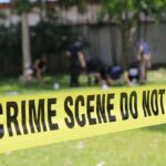 Released 911 Captures FRANTIC Karmelo Anthony After Killing! crime scene tape cordoning off a grassy area