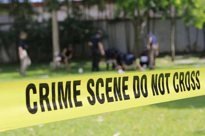 crime scene tape cordoning off a grassy area