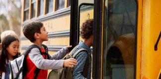 Children boarding a yellow school bus