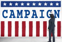 Censure Bombshell Ends GOP Campaign Overnight Man in suit writing on large campaign banner with stars and stripes