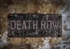 Execution Goes WOKE, All-Female Team Requested Rusty metal sign on worn concrete wall