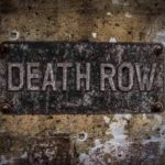 Rusty metal sign on worn concrete wall