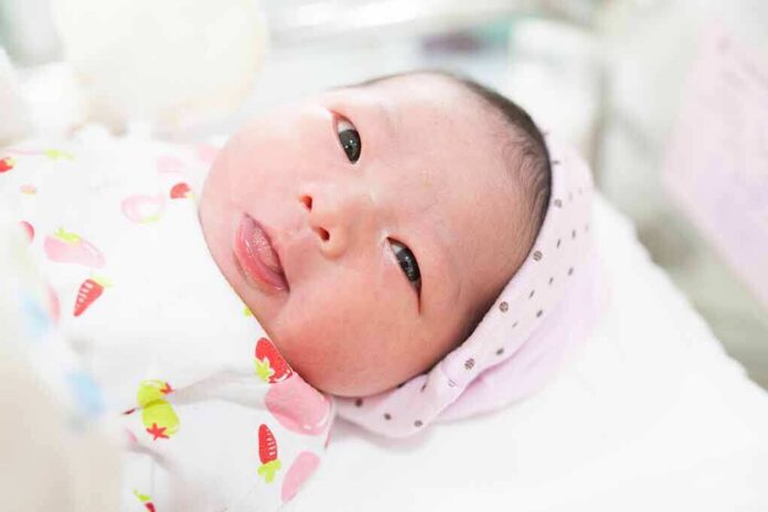 newborn baby lying on a blanket