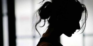 silhouette of a woman in profile against a bright window