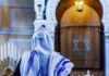 El-Sayed’s ‘Lesbian Rosh Hashanah’ Plan BACKFIRES Spectacularly Person in white and blue prayer shawl facing ornate interior