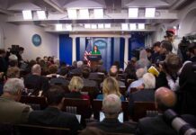 Trump Aide Files RESTRAINING Order Against GOP Congressman Press secretary at podium addressing reporters in briefing room