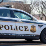 Record Threat Spike Jolts Secret Service United States Secret Service police car on roadside.
