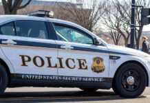 Record Threat Spike Jolts Secret Service United States Secret Service police car on roadside.