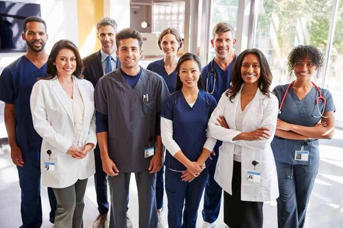 Group of healthcare professionals posing in a hospital corridor