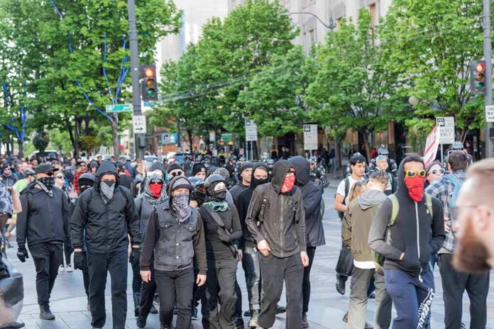 group of masked protesters walking through a city street