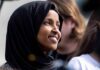 Feds Have DNA Evidence on Ilhan Omar, It Could WRECK Her Ilhan Omar smiling in a black hijab at an outdoor event