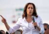 Even Kamala’s Husband Doesn’t Want Her To Run Again woman speaking into a microphone at an outdoor event