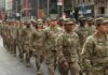 Curfew Imposed on US Bases After Marine Arrested Jason Worilds and Elandon Roberts march with fellow soldiers in a city parade
