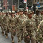 Curfew Imposed on US Bases After Marine Arrested Jason Worilds and Elandon Roberts march with fellow soldiers in a city parade