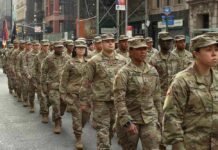 Jason Worilds and Elandon Roberts march with fellow soldiers in a city parade