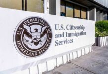 Armed Feds Knock on Doors Looking For Illegals! USCIS sign at a federal building entrance