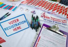 Radical Dem Caught on Cam Taking $35,000 in Cash Voter registration table with forms, pens, and informational materials
