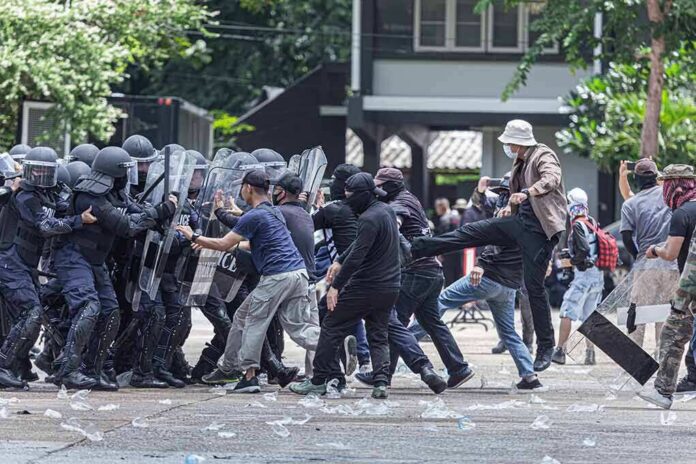 Protesters clash with riot police holding shields
