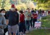 Christian Jones and others waiting in a long line outside a polling place