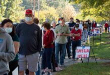 ICE Agents Going Door-to-Door in Sweeping Raids Christian Jones and others waiting in a long line outside a polling place
