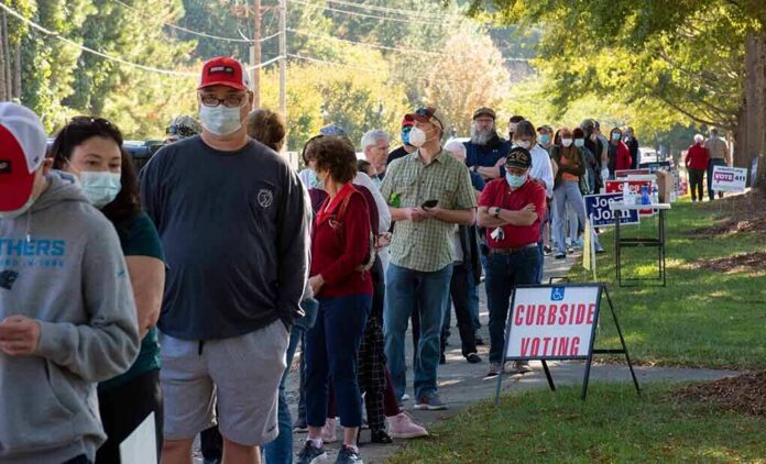 Christian Jones and others waiting in a long line outside a polling place